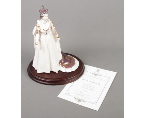 A Royal Worcester limited figure of Queen Elizabeth II depicted in full coronation dress. From the Queens of Britain series, 