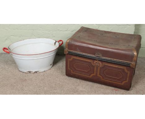 A twin handled tin trunk along with an enamel tub.  
