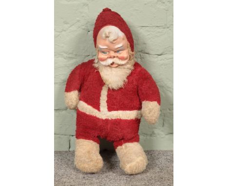 A vintage rubber Santa doll; 51cm tall.  