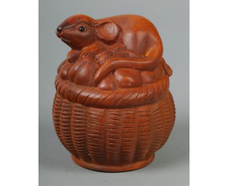 A hand carved hardwood netsuke of a mouse on basket, signed to base.  