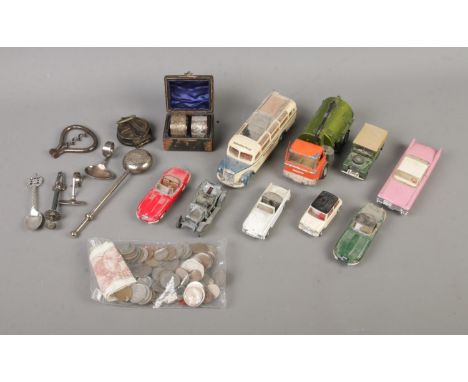 An assortment of collectables to include Dinky Diecast, silver plate, compass, international coins, etc.  