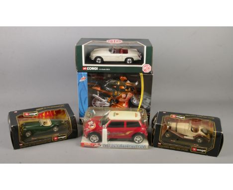 A quantity of boxed diecast vehicles. Includes Corgi 1963 MGB Roadster 1:18 scale, Burago examples, etc.  