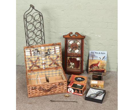 A box of miscellaneous to include Halcyon motorcycle glasses, wicker picnic hamper, wine rack, 31 day clock, etc.  