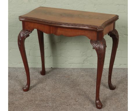A mahogany carved fold over card table with cabriole legs. Manufacturers label "Maple Quality"Hx78cmWx82cmDx42cm  