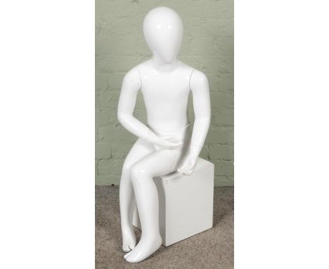A shop mannequin formed as a seated child. (Hx100cm)  