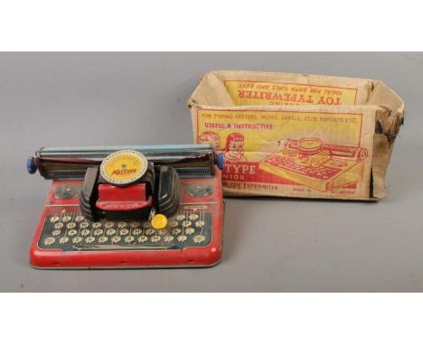 A vintage tin plate Mettype Junior typewriter with original box.  Box is in very bad condition.