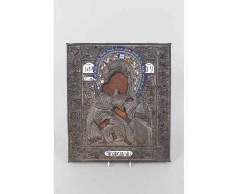 A 19th Century Russian ikon of the Madonna and Child with metal and enamel oklad and Cyrillic lettering, 12" x 11"