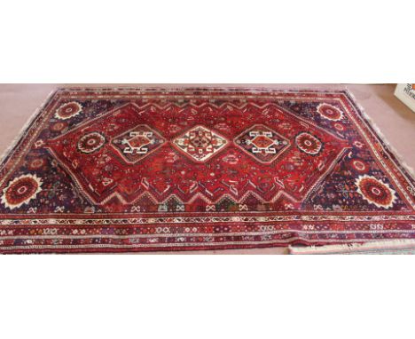 A Persian red ground carpet, 120" x 88"