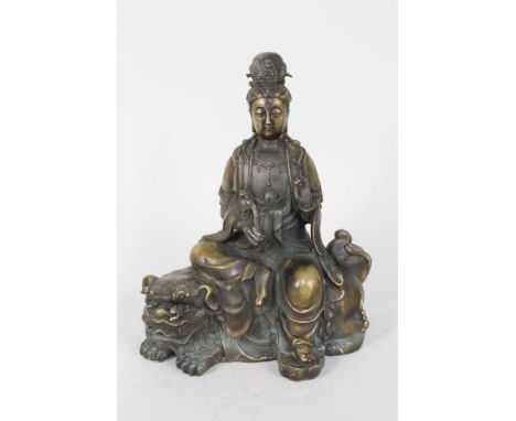 A Chinese bronze of a female deity seated upon a kylin, seal marks, height 10"