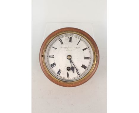 A circular oak wall clock by the Goldsmiths &amp; Silversmiths Co