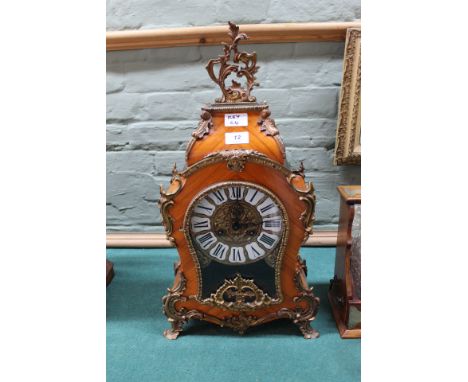 A reproduction French style kingwood and gilt metal waisted mantel clock with German movement