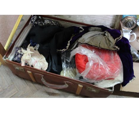 A trunk containing vintage clothing and hats etc including a mauve velvet childs waistcoat