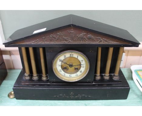 A black marble striking mantel clock