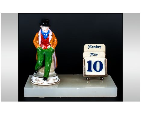 A Small Figural and SIlver Desk Calendar. The Ceramic Artful Dodger Figure and Sterling Silver Day, Date & Calendar Raised on