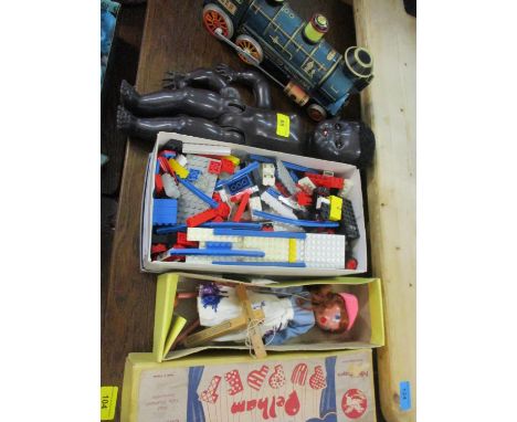 A vintage Pedigree black doll, a Pelham puppet of a young girl in original box, retro Lego bricks and a Japanese train 