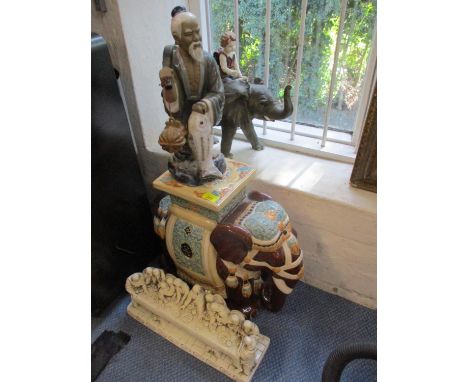 A Japanese export plant stand in the form of a ceramic elephant, together with a figure of a Japanese fisherman and other cer