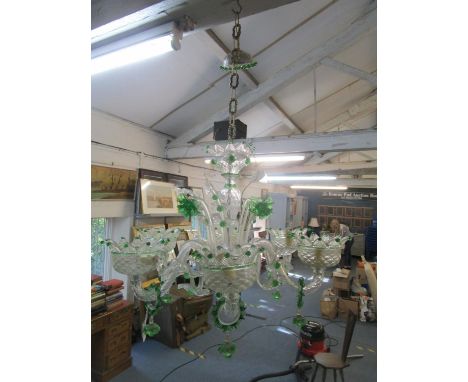 A traditional Venetian green and clear glass six branch chandelier with four daffodil stems and ten leaf stems, having quilte