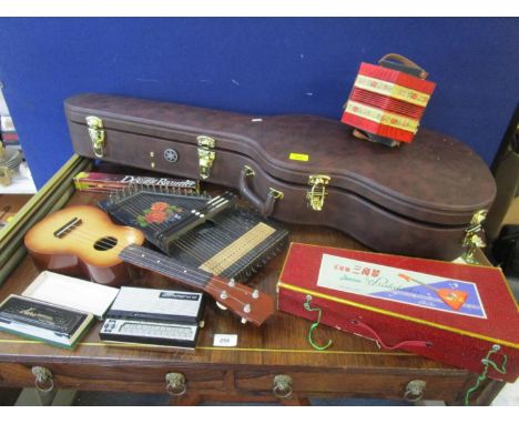 A selection of musical instruments to include a boxed Balalaika stylophone, zither, Heco harmonica and others, along with a g