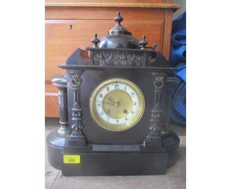 A late 19th century black slate mantle clock fitted with a German 8 day movement, striking on a gong, 39" h x 37"w 