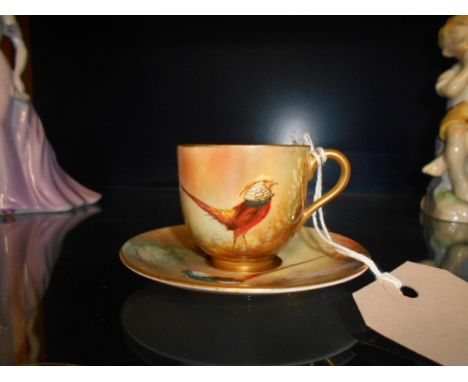 A Royal Worcester hand painted cabinet cup and saucer with pheasant decoration