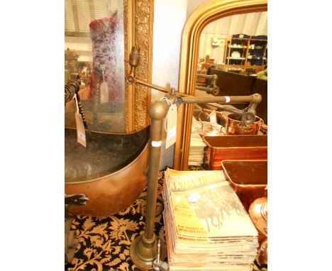 A vintage brass desk lamp with moveable arm 