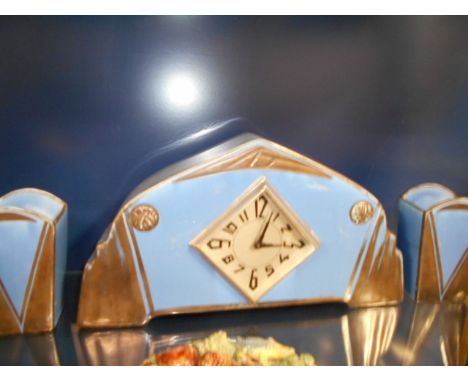 A French Art Deco blue glazed ceramic clock garniture of geometric form 