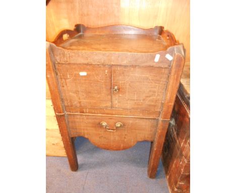 A Georgian inlaid mahogany commode the galleried top above a pair of cupboard doors and shaped drawer legs