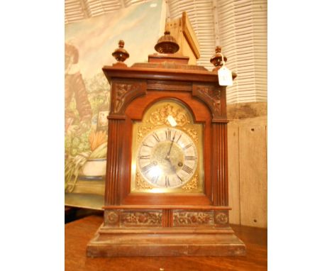 A German oak cased bracket clock of architectural form, the enamel dial having Roman numerals 