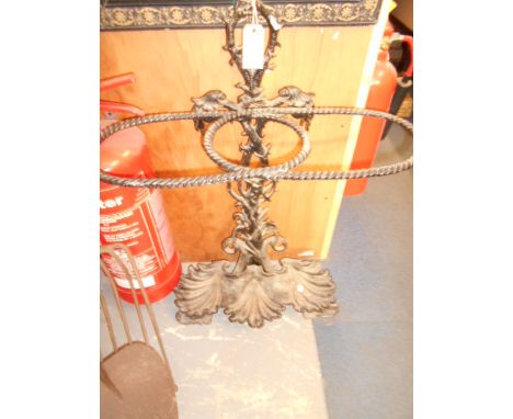 A Victorian style cast metal stick stand having ornate floral frame and shell shaped basket