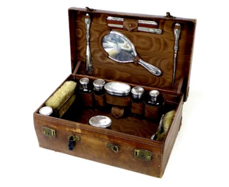 An Edwardian silver and cut glass ladies leather bound brown vanity case, monogramed 'A.I.C.', fitted with dressing table jar