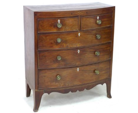 A George IV mahogany and inlaid chest, of two short over three long drawers, raised on bracket feet, 101.5 by 52 by 117.5 cm 
