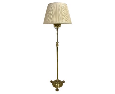 Edwardian brass plated copper standard lamp, telescopic stem on lobe moulded circular base with three projecting paw feet, wi