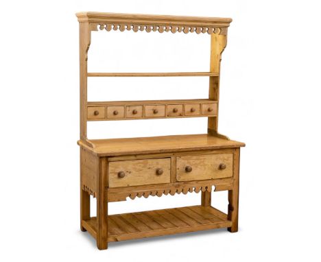 Early to mid-19th century pine cottage dresser, projecting cornice over fretwork frieze, the rack fitted with two shelves ove