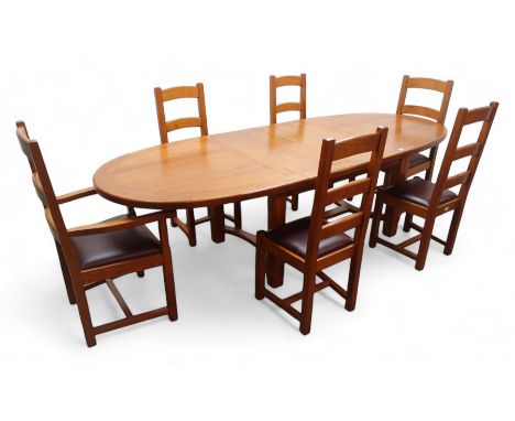 French solid oak oval extending dining table with two leaves, square supports joined by curved 'H' stretcher; set of six (4+2