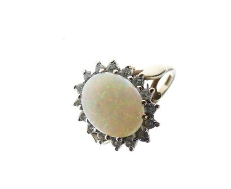 9ct gold, opal and diamond dress ring set oval opal approximately 10mm x 8mm, within sixteen small diamonds, size M, 2.5g gro