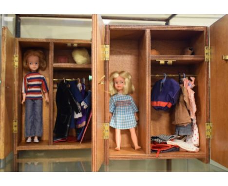 Two vintage Sindy Dolls, within wooden wardrobes having various clothing and accessories, together with some Pippa Dolls and 