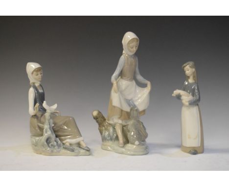 Three Lladro porcelain figures, girl with rabbit, girl with dove and girl with pig, the first 22.5cm high (3)  
