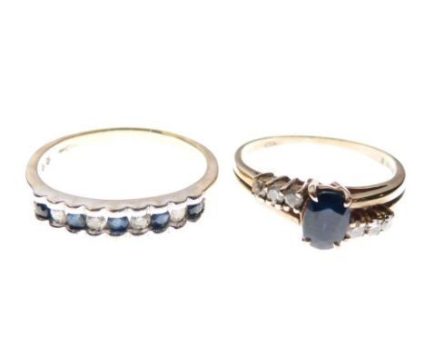 Two 9ct gold rings, the first set central faceted oval sapphire between three small diamonds to each side, size M, the second