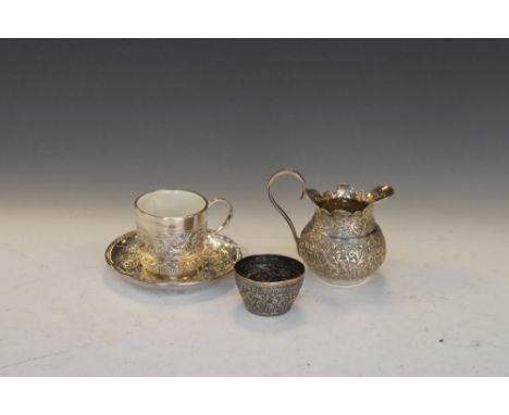 Indian white metal cream jug and tea bowl, together with a late Victorian patent tea cup, the ceramic body with outer silver 