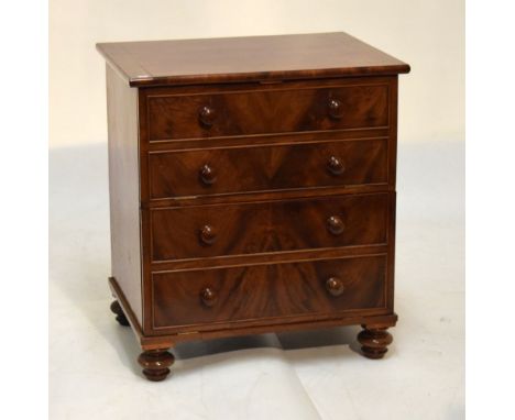 19th Century mahogany commode chest, later converted to music cabinet with false four-drawer front on bun supports, 65cm wide