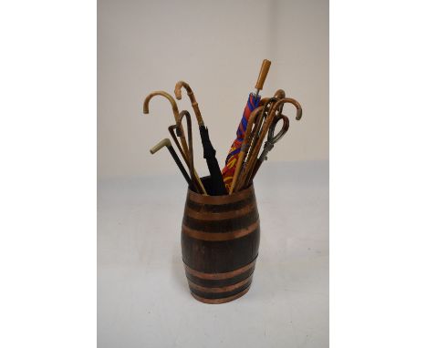 Copper-bound coopered barrel, 51cm high containing a selection of sticks, shooting stick, umbrellas, etc  