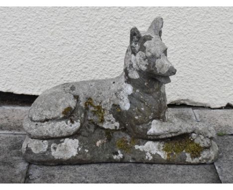 Reconstituted garden ornament modelled as a reclining Alsatian or German Shepherd, 48cm wide  