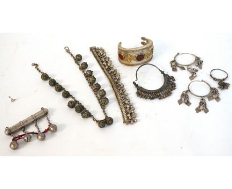 SELECTION OF WHITE METAL TRIBAL JEWELLERY 
including a stone set bangle, bracelets and earrings with ball and bell decoration