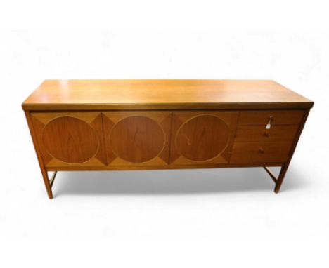 A mid-century Nathan 'Circles' teak sideboard, with two doors opening to reveal shelves, a drop down front drinks cabinet and