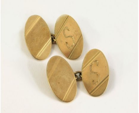 GOLD CUFFLINKS. A pair of 9ct. gold engine turned cufflinks. Approx. 6.6g.