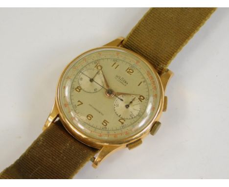 GOLD WATCH. A gentleman's 18ct. gold cased Delbana Chronograph wristwatch, c.1950. The dial with push button stop-start reset