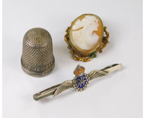 CAMEO ETC.A carved cameo shell brooch in gilt metal mount, a silver & enamel RAF sweetheart pin & a silver advertising thimbl