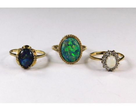 OPAL RINGS. A 9ct, gold opal cluster ring &amp; two 9ct. gold opal doublet rings. Approx. 5.8g.