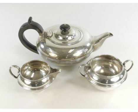 TEA SERVICE. A silver matched three piece tea service. Cream jug &amp; sugar bowl, London 1908/9, the teapot Sheffield 1911. 