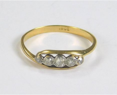 GOLD RING. An 18ct. gold five stone diamond ring. (K)